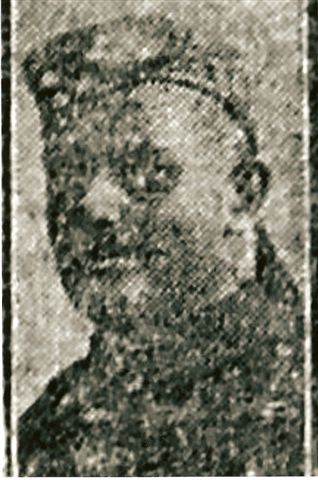 poor quality copy of a photograph of his head and shoulders in his army uniform and wearing a cap