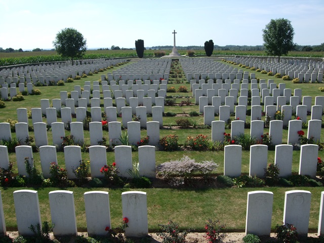 Grand-Seraucourt British Cemetery with gravestones in rows running across the hill    