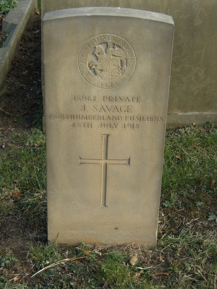 close up of john's gravestone giving his regimental badge at the top, his details and the date of his death which has been inscribed wrongly as 1918 instead of 1916