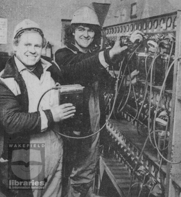 A black and white photograph of miners hanging up their lamps at the pit head for the last time as Glasshoughton Colliery, Castleford, closes.  The colliery once employed 4,000 men and produced 1 million tonnes of coal a year.  At the time of its closure in 1986 it employed 350 men.  Internal Reference: PO N111