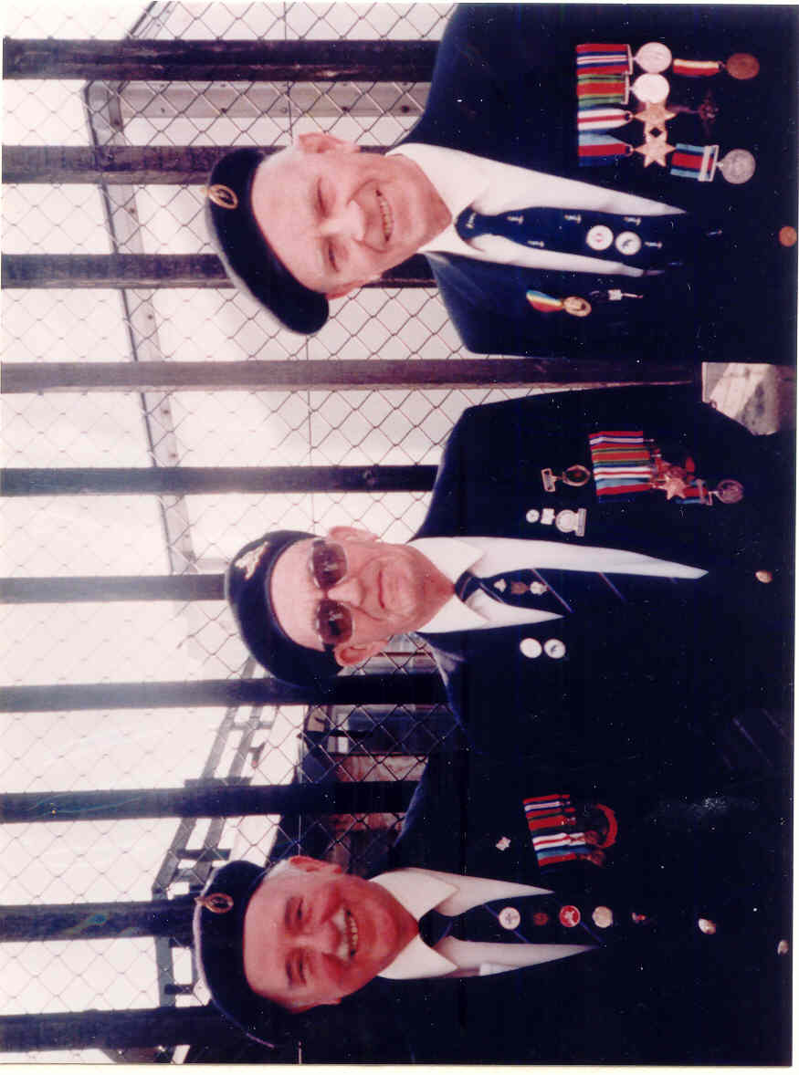 Colour photograph of Leslie Thompson on the right with tow of his comrades. Taken 1994 and they are wearing their medals and caps