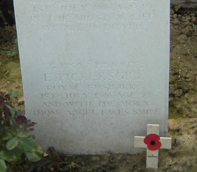 close up of ernest's white gravestone so his details are more easily read. his name, service number and date of death are given and the words and in the morn those angel faces smile are also inscribed on his gravestone