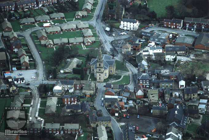 A colour aerial photograph of Horbury Church, seen centre, dedicated to Saint Peter and Saint Leonard.  Church Street runs down from the top, past the church and onto Queen Street.  Internal Reference: WR (LS)