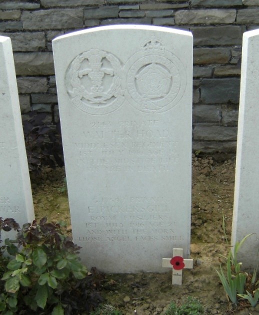 the white gravestone of Ernest pickersgill which unusually has two names on it with ernest's being the bottom one. it gives his regimental badge, details of his name and date of death and the words and in the morn those angel faces smile
