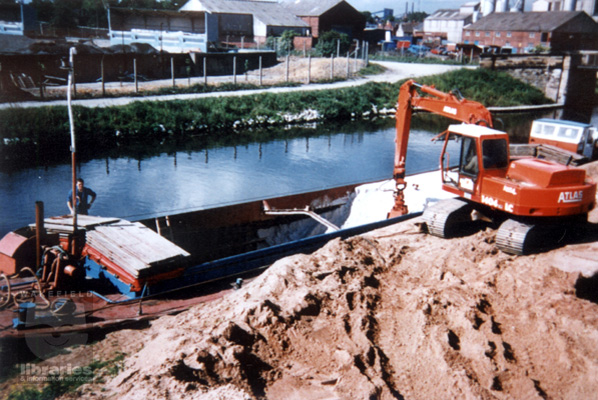 A colour photograph of 'Mossdale', now a dry cargo boat owned by Branford's, discharging sand at Stantons Wharf, Bank Dole Lock, Knottingley.  Internal Reference: Private Collection