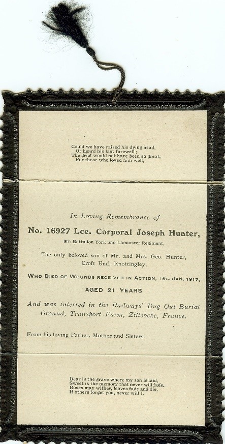 A memorial card which his family had printed which gives his details and some verses. it has a black border and black tassel attached