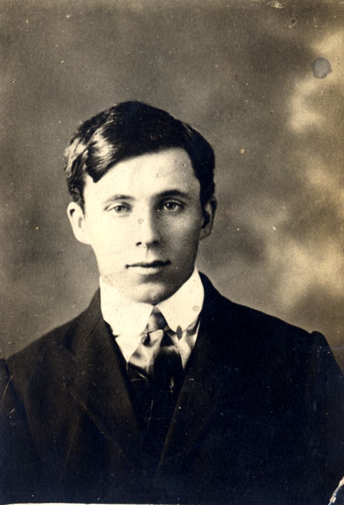 john as a young man wearing a suit