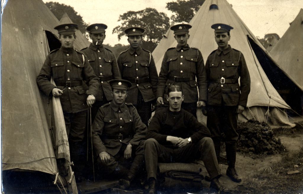 a group of soldiers standing outside some tents. Alfred parkin is on the back row far right