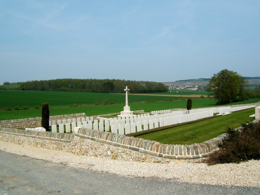 Bouilly Cross Roads Military Cemetery with a graveyard enclosed by a stone wall