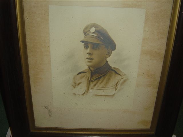 framed photograph of the head and shoulders of edward wearing his army uniform and army cap