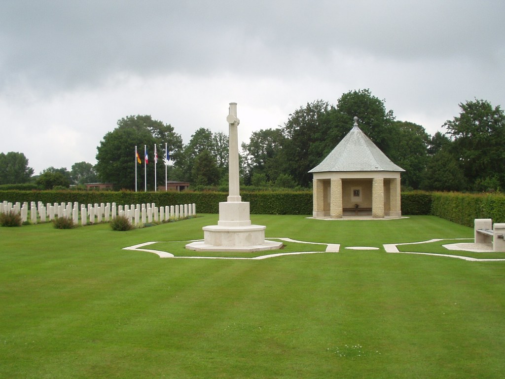 St Desir War Cemetery Calvados with the Cross of Sacrifice in the middle and rows of gravestones off to the side